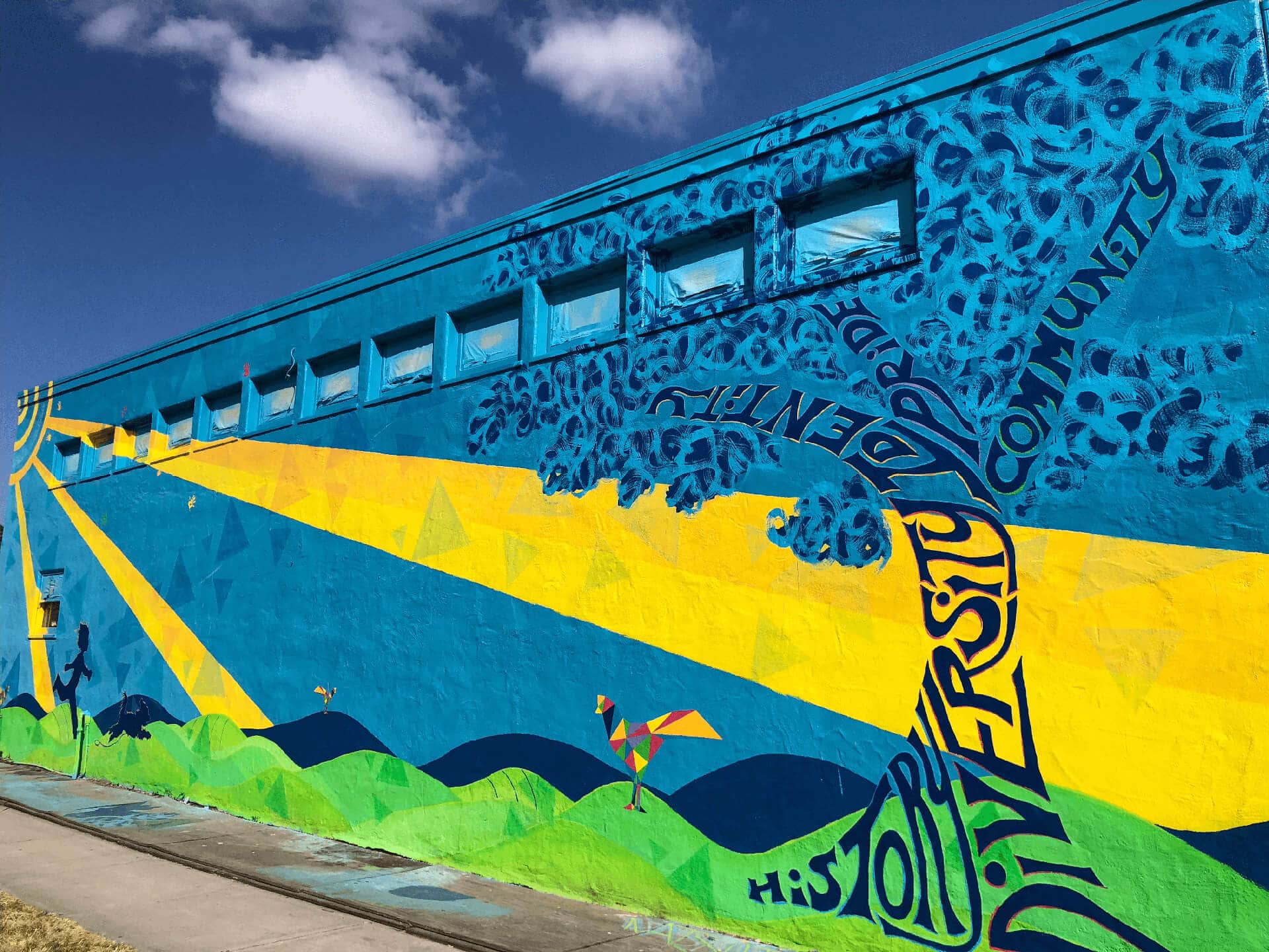Social Cause Marketing Through Public Art And Design - 2025 Interim 10 Mural - community creates the future aka "tommy" | 18′ x 65′ | escondido, ca | 2023 grant through escondido community foundation in partnership with escondido arts association, suki leibow, & mandala creative the message in the tree: “history, diversity, identity, community, pride”, combined with hand prints collected from within the community celebrates its vibrancy and brings light to a primary entrance into escondido. 1,200 sf mural on stucco on 100+ year old historic building public art work | nonprofit | social issue art